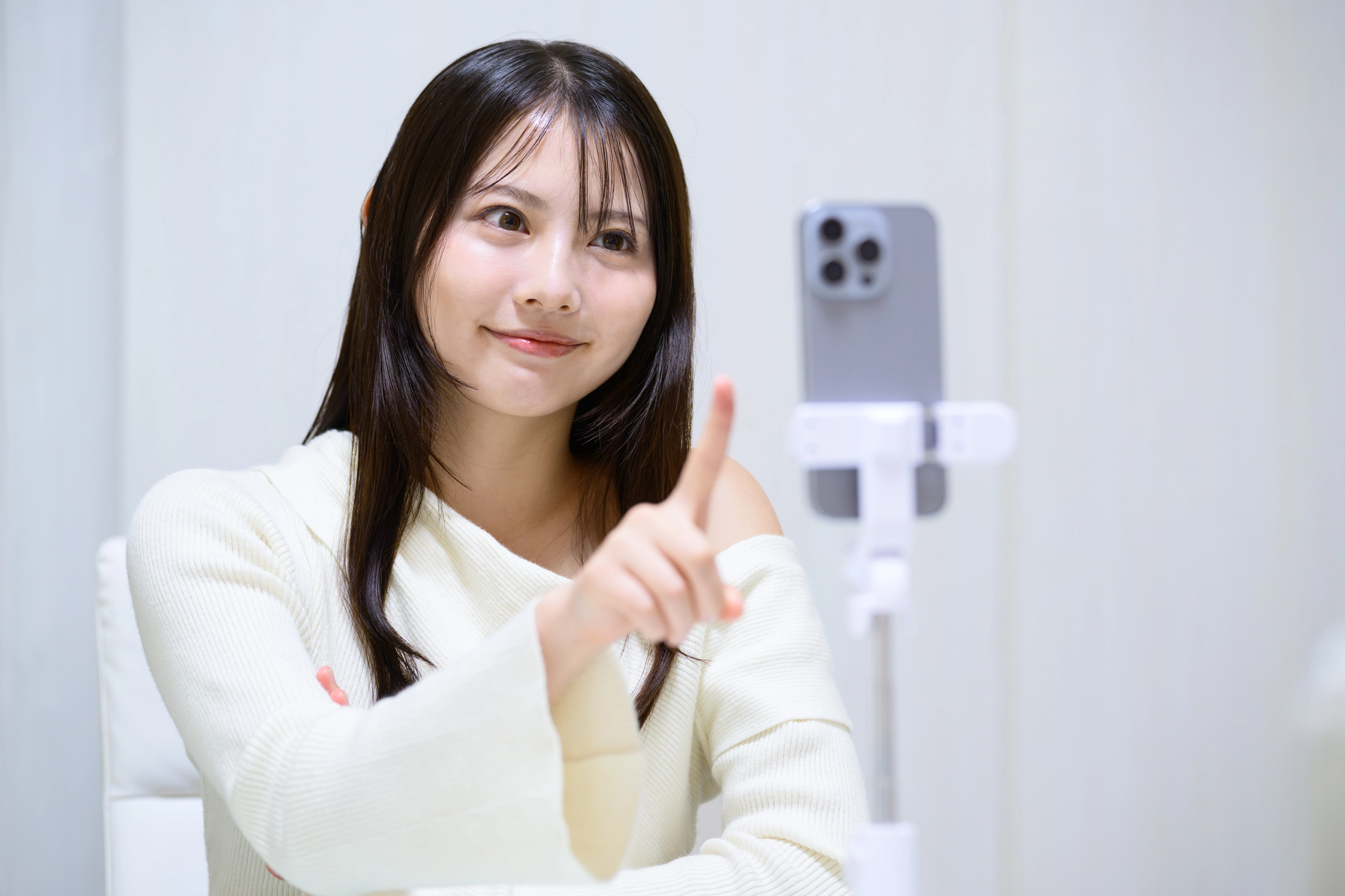 白いトップスを着て在宅ワークをする女性